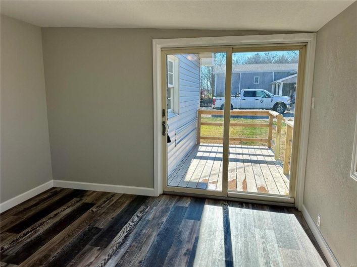 Doorway to outside with dark hardwood / wood-style floors and lofted ceiling