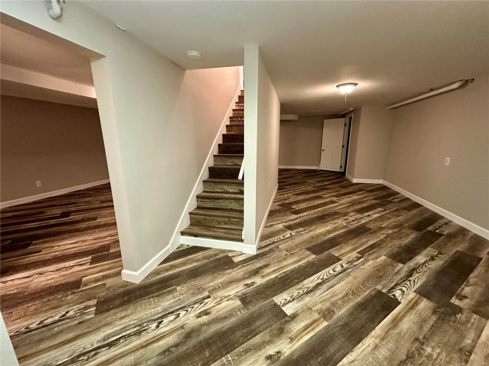 Staircase featuring hardwood / wood-style floors