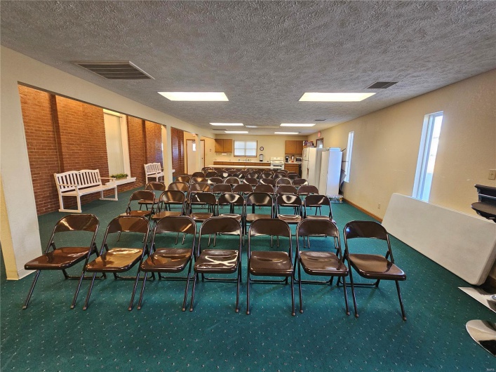 Interior space with a textured ceiling and carpet floors