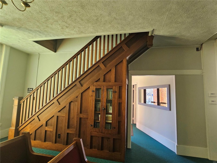 Stairs featuring carpet flooring and a textured ceiling