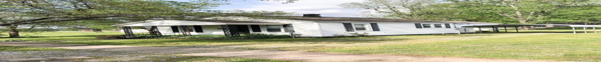 Residential For Sale View of front of home with a carport, covered porch, and a front lawn