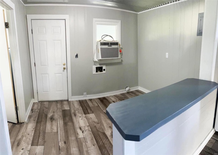 Interior space with hardwood / wood-style floors and ornamental molding