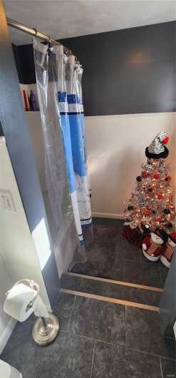 Bathroom featuring curtained shower
