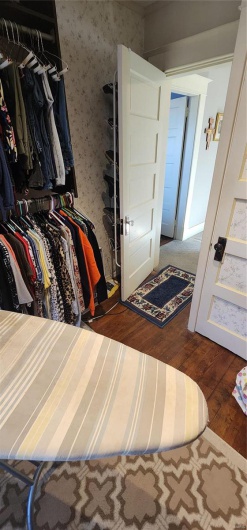 Spacious closet featuring dark hardwood / wood-style flooring