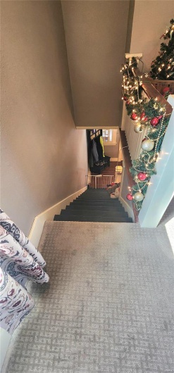 Staircase featuring carpet flooring