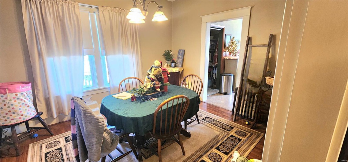 Dining room with a notable chandelier and hardwood / wood-style flooring