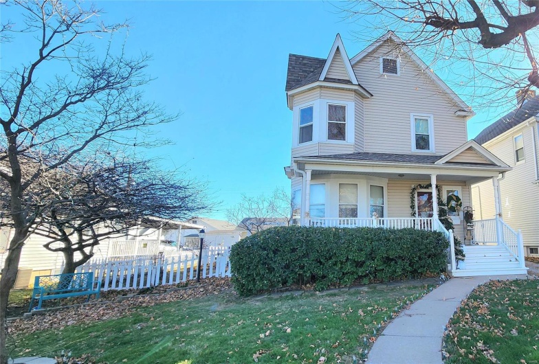 Victorian house with a porch and a front yard