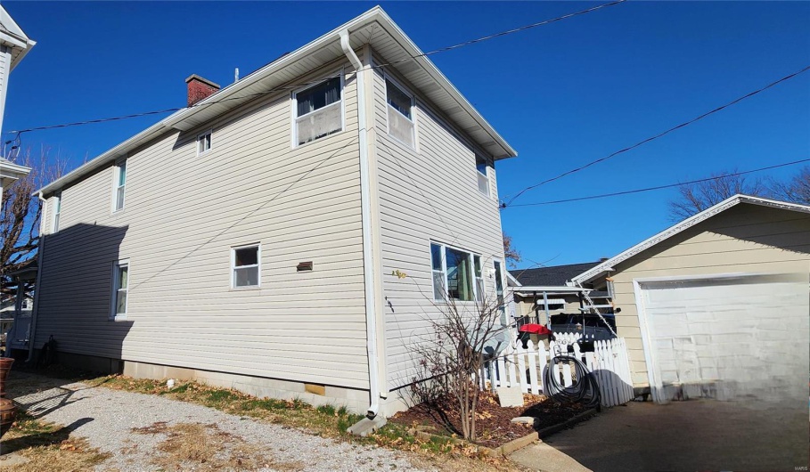 View of side of home with a garage