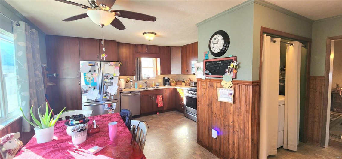 Kitchen with ceiling fan, ornamental molding, sink, and appliances with stainless steel finishes