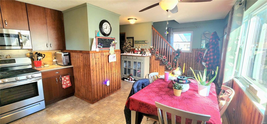Kitchen featuring ceiling fan, appliances with stainless steel finishes, and tasteful backsplash