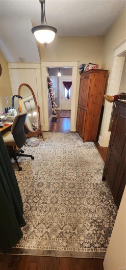 Hall featuring dark wood-type flooring