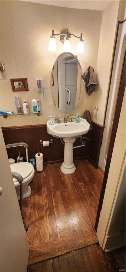Bathroom featuring toilet and hardwood / wood-style flooring