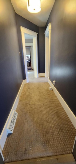 Hallway with carpet floors