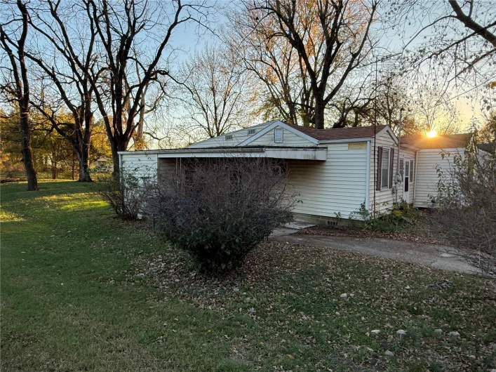 Property exterior at dusk with a yard