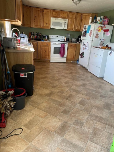 Kitchen with range, washer / clothes dryer, and fridge