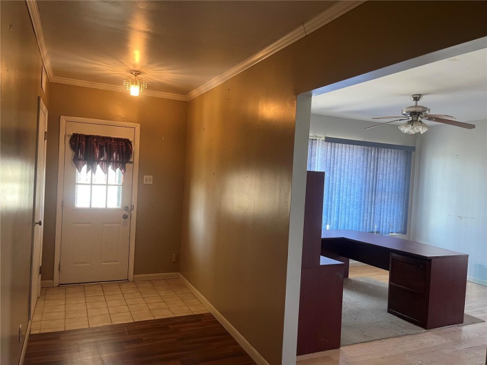 Foyer featuring baseboards, light wood-style floors, ceiling fan, and ornamental molding