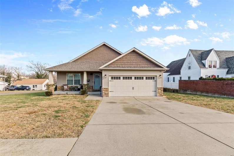 Craftsman-style home with a garage and a front lawn