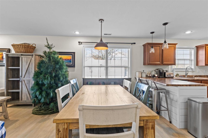 Dining room with light hardwood / wood-style floors, plenty of natural light, and sink