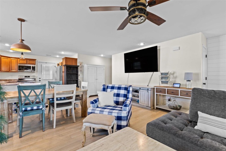 Living room with light hardwood / wood-style flooring and ceiling fan