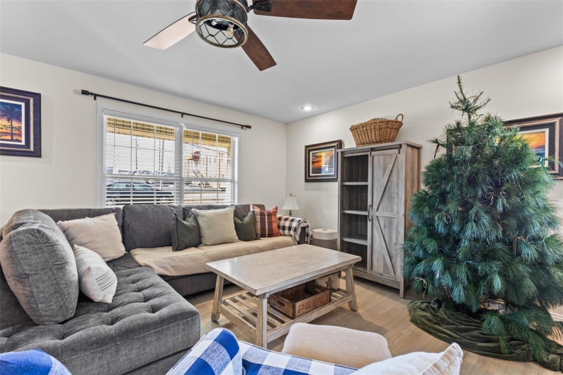 Living room featuring ceiling fan and light wood-type flooring