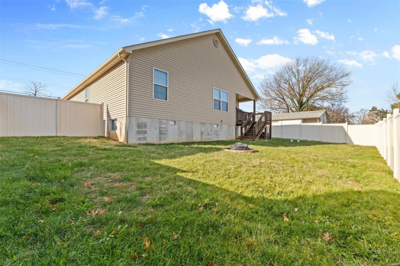 Rear view of property with a yard and a wooden deck