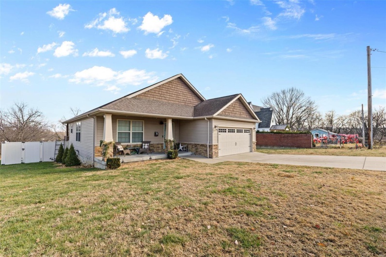 View of front of house with a front yard and a garage