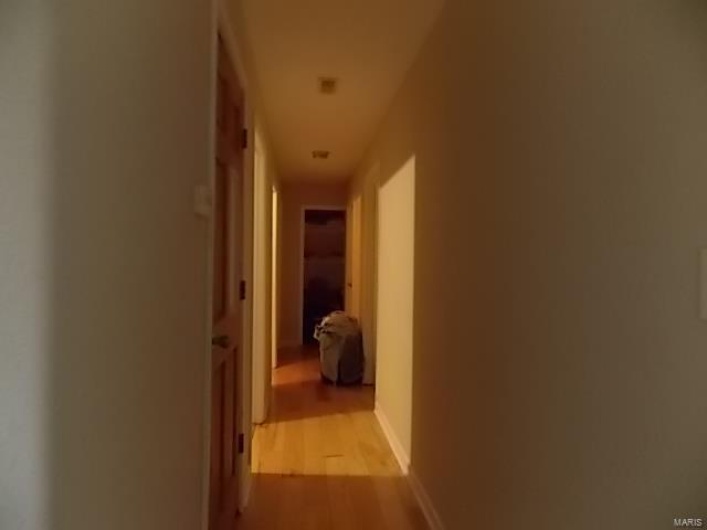 Corridor with light hardwood / wood-style floors