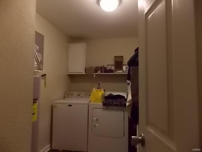Washroom with cabinets and washing machine and dryer
