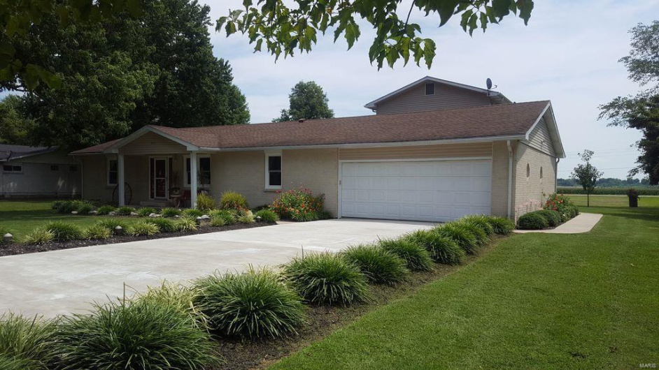 Ranch-style home with a front lawn and a garage