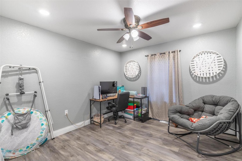 Home office featuring ceiling fan and hardwood / wood-style flooring