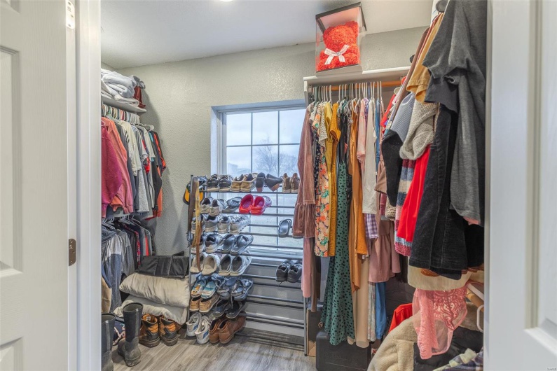Spacious closet with hardwood / wood-style floors