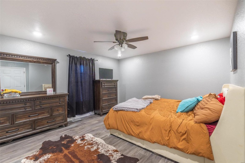 Bedroom featuring ceiling fan and light wood-type flooring