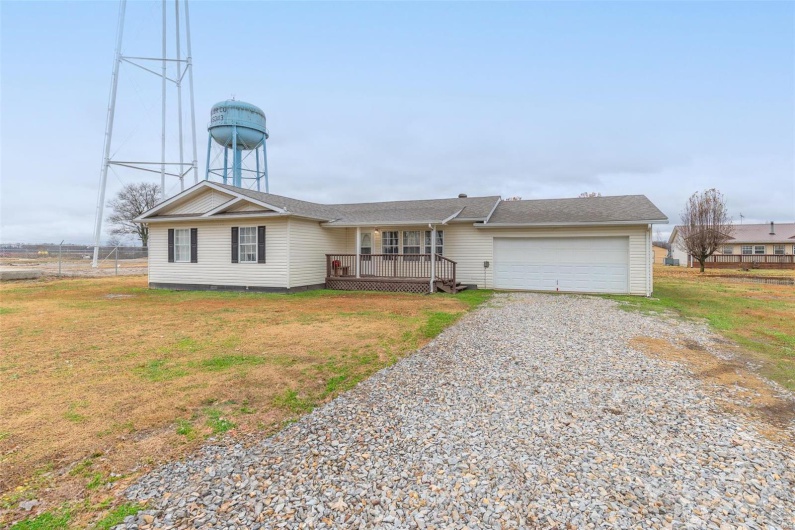 Ranch-style home with a front yard and a garage