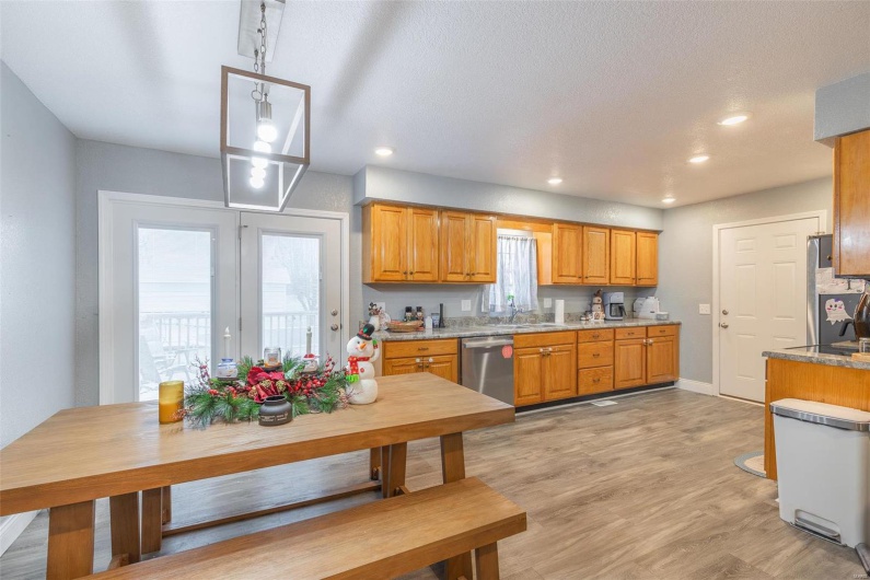 Kitchen featuring a healthy amount of sunlight, sink, light wood-type flooring, and stainless steel appliances