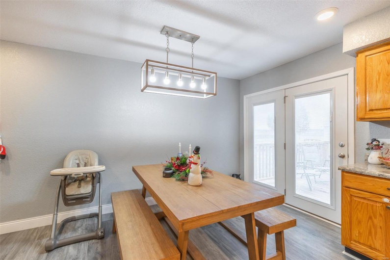 Dining area featuring wood-type flooring and a healthy amount of sunlight