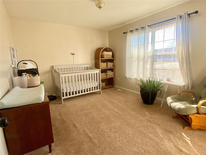 Bedroom with carpet flooring and a nursery area