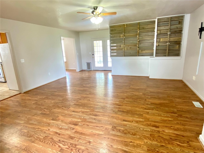 Empty room featuring baseboards, ceiling fan, and wood finished floors