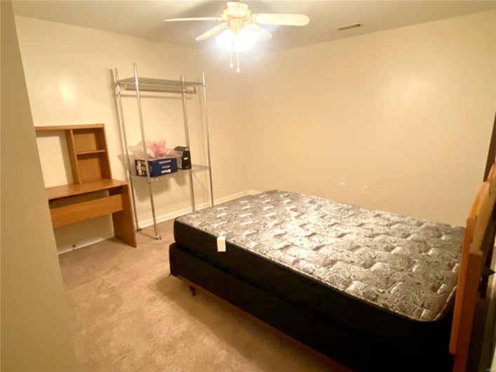 Carpeted bedroom with ceiling fan