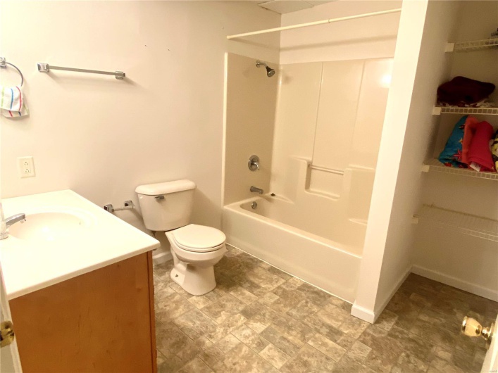 Full bathroom featuring vanity, toilet, and shower / washtub combination