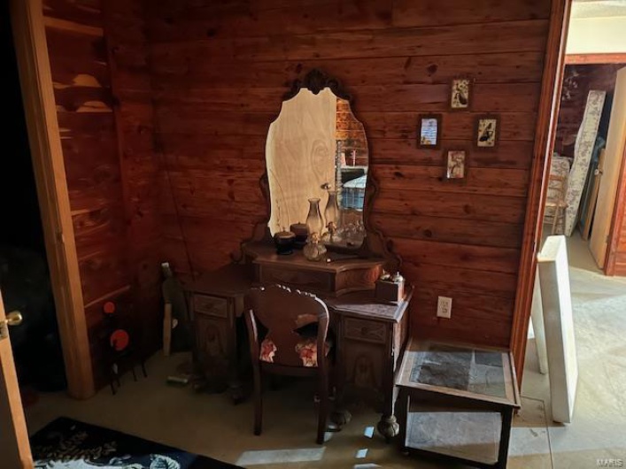 Miscellaneous room featuring wood walls