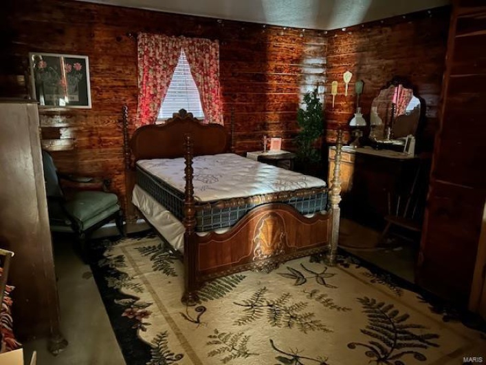 Bedroom with wood walls