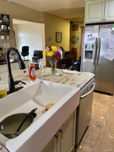Kitchen featuring sink, stainless steel appliances, and cream cabinetry