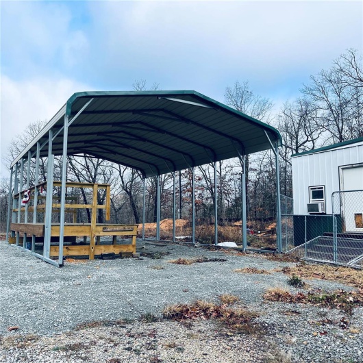 View of parking featuring a carport