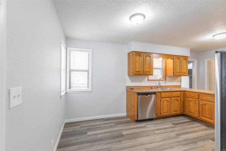 Kitchen with stainless steel appliances, light hardwood / wood-style flooring, a wealth of natural light, and sink