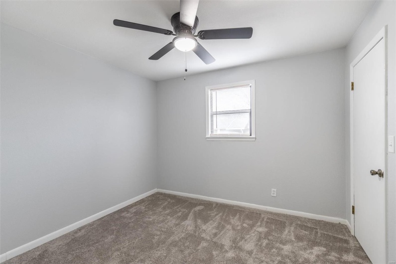 Empty room with carpet and ceiling fan