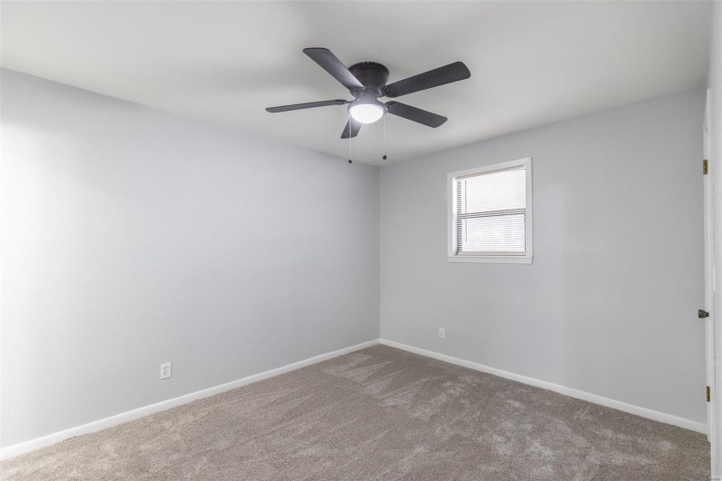 Spare room with ceiling fan and carpet