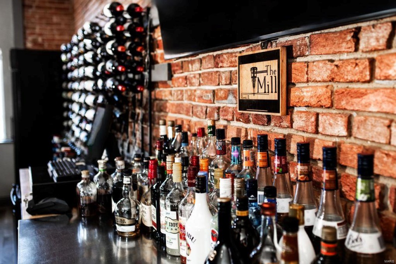 Wine room featuring brick wall