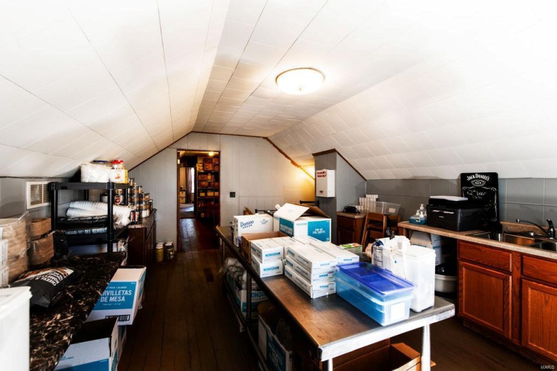 Business office featuring sink, vaulted ceiling, and dark hardwood / wood-style floors