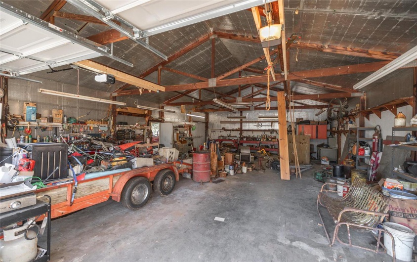 Garage featuring a workshop area and a garage door opener