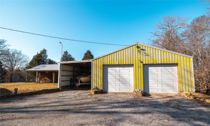 Garage featuring a carport